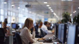 Busy open-plan office with workers at desks and on the phone Generative AI